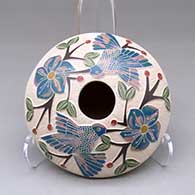 A polychrome seed pot decorated with a lightly carved, sgraffito and painted hummingbird, vine, flower and berry design
 by Melissa Tena of Mata Ortiz and Casas Grandes