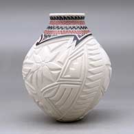 A polychrome vase decorated with a carved hummingbird, dragonfly and geometric design around the body and a sgraffito and painted geometric design around the short neck, click or tap to see a larger version