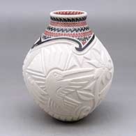 A polychrome vase decorated with a carved hummingbird, dragonfly and geometric design around the body and a sgraffito and painted geometric design around the short neck
 by Martin Olivas of Mata Ortiz and Casas Grandes