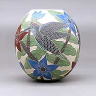 A polychrome jar decorated with a sgraffito and painted hummingbird, butterfly, flower, leaf and branch design, click or tap to see a larger version