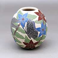 A polychrome jar decorated with a sgraffito and painted hummingbird, butterfly, flower, leaf and branch design
 by Karla Flores of Mata Ortiz and Casas Grandes