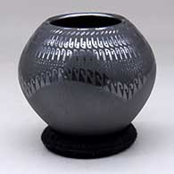 A black jar with a four panel sgraffito and painted geometric design
 by Susy Martinez of Mata Ortiz and Casas Grandes