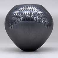 A black on black jar decorated with a geometric design, click or tap to see a larger version