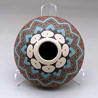 A polychrome seed pot decorated above the shoulder with a checkerboard and geometric design
 by Julio Mora of Mata Ortiz and Casas Grandes