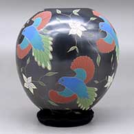 A polychrome jar decorated with a sgraffito and painted bird, flower and vine design, click or tap to see a larger version