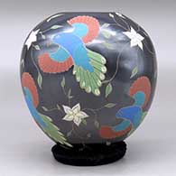 A polychrome jar decorated with a sgraffito and painted bird, flower and vine design, click or tap to see a larger version