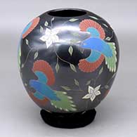 A polychrome jar decorated with a sgraffito and painted bird, flower and vine design
 by Elicena Cota of Mata Ortiz and Casas Grandes