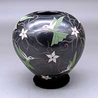 A polychrome jar decorated with a sgraffito and painted hummingbird, vine and flower design
 by Elicena Cota of Mata Ortiz and Casas Grandes