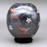 A polychrome jar decorated with a sgraffito and painted hummingbird, flower and vine design, click or tap to see a larger version