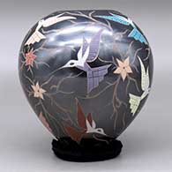 A polychrome jar decorated with a sgraffito and painted hummingbird, flower and vine design, click or tap to see a larger version