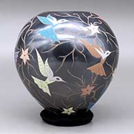 A polychrome jar decorated with a sgraffito and painted hummingbird, flower and vine design, click or tap to see a larger version