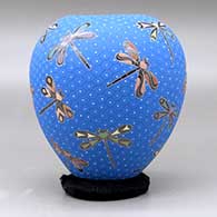 A polychrome jar decorated with a sgraffito and painted dragonfly and geometric mesh design, click or tap to see a larger version