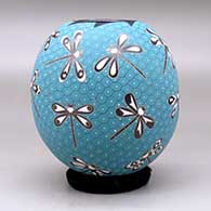 A polychrome jar decorated with a sgraffito and painted dragonfly and geometric mesh design, click or tap to see a larger version