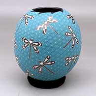A polychrome jar decorated with a sgraffito and painted dragonfly and geometric mesh design
 by Elicena Cota of Mata Ortiz and Casas Grandes