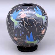 A polychrome jar decorated with a sgraffito and painted hummingbird, flower and vine design
 by Elicena Cota of Mata Ortiz and Casas Grandes