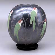 A polychrome jar decorated with a sgraffito and painted parrot and vine design, click or tap to see a larger version