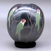 A polychrome jar decorated with a sgraffito and painted parrot and vine design, click or tap to see a larger version