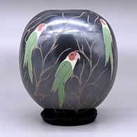 A polychrome jar decorated with a sgraffito and painted parrot and vine design, click or tap to see a larger version