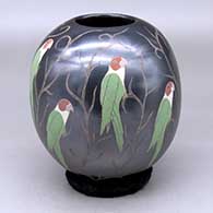 A polychrome jar decorated with a sgraffito and painted parrot and vine design
 by Elicena Cota of Mata Ortiz and Casas Grandes
