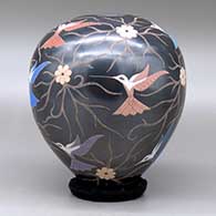 A polychrome jar decorated with a sgraffito and painted hummingbird, flower and vine design, click or tap to see a larger version