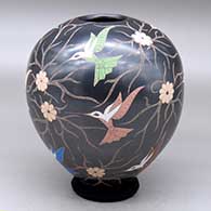 A polychrome jar decorated with a sgraffito and painted hummingbird, flower and vine design
 by Elicena Cota of Mata Ortiz and Casas Grandes