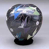 A polychrome jar decorated with a sgraffito and painted hummingbird, vine and flower design, click or tap to see a larger version