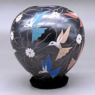 A polychrome jar decorated with a sgraffito and painted hummingbird, vine and flower design, click or tap to see a larger version