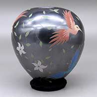 A polychrome jar decorated with a bird, branch, flower and leaf design, click or tap to see a larger version