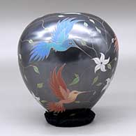 A polychrome jar decorated with a bird, branch, flower and leaf design, click or tap to see a larger version