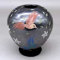 A polychrome jar decorated with a bird, branch, flower and leaf design
 by Elicena Cota of Mata Ortiz and Casas Grandes