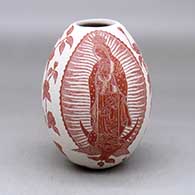 A red on white jar decorated with a Virgin of Guadalupe, rose, vine and geometric design
 by Hector Javier Martinez of Mata Ortiz and Casas Grandes