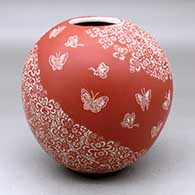 A red on white jar decorated with a sgraffito butterfly and geometric design
 by Hector Javier Martinez of Mata Ortiz and Casas Grandes