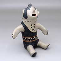 A sitting singing grandfather figure
 by Damacia Cordero of Cochiti