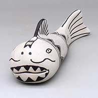 A black-on-white fish figure decorated with a fish and geometric design
 by Guadalupe Ortiz of Cochiti