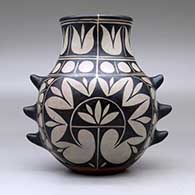 A polychrome jar with handles and decorated with a geometric design around the body, click or tap to see a larger version
