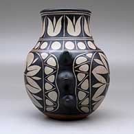 A polychrome jar with handles and decorated with a geometric design around the body, click or tap to see a larger version