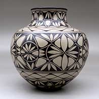 A polychrome jar decorated with a geometric design, click or tap to see a larger version