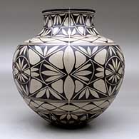A polychrome jar decorated with a geometric design, click or tap to see a larger version