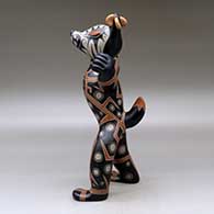 Standing polychrome coyote figure with earrings and a geometric design, click or tap to see a larger version