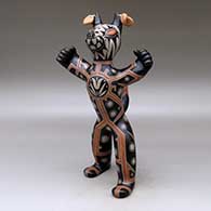 Standing polychrome coyote figure with earrings and a geometric design, click or tap to see a larger version