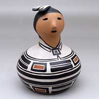 A polychrome human effigy jar with a feather on its head and decorated around the body with a geometric design
 by M Janice Ortiz of Cochiti