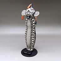 Old man caterpillar with earrings and a geometric design
 by Virgil Ortiz of Cochiti