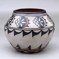 A polychrome jar decorated with a raincloud and geometric design around the shoulder and the base
 by Virgil Ortiz of Cochiti