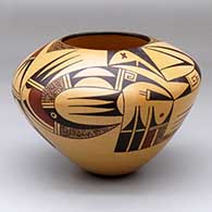 A polychrome bowl decorated with a singular bird element and geometric design
 by Garrett Maho of Hopi