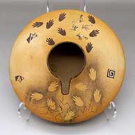 A polychrome Sikyatki-style jar decorated with bird, hand and geometric design, with an organic opening
 by Jacob Koopee of Hopi