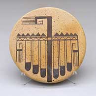 A black-on-yellow round tile decorated with a thunderbird tail and geometric design
 by Darlene Nampeyo of Hopi