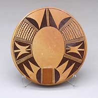 A polychrome round tile decorated with a bird element and geometric design
 by Darlene Nampeyo of Hopi