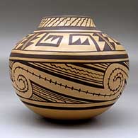 A brown on  tan jar decorated with a four-panel geometric design, click or tap to see a larger version