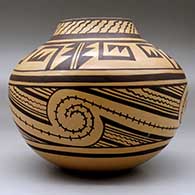 A brown on  tan jar decorated with a four-panel geometric design, click or tap to see a larger version