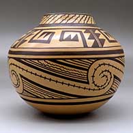 A brown on  tan jar decorated with a four-panel geometric design, click or tap to see a larger version